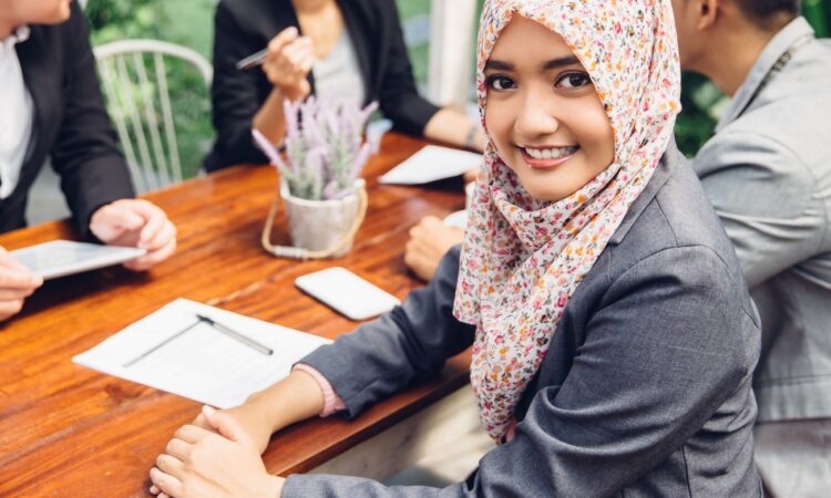 Attractive asian businesswoman smiling at the camera during a business meeting